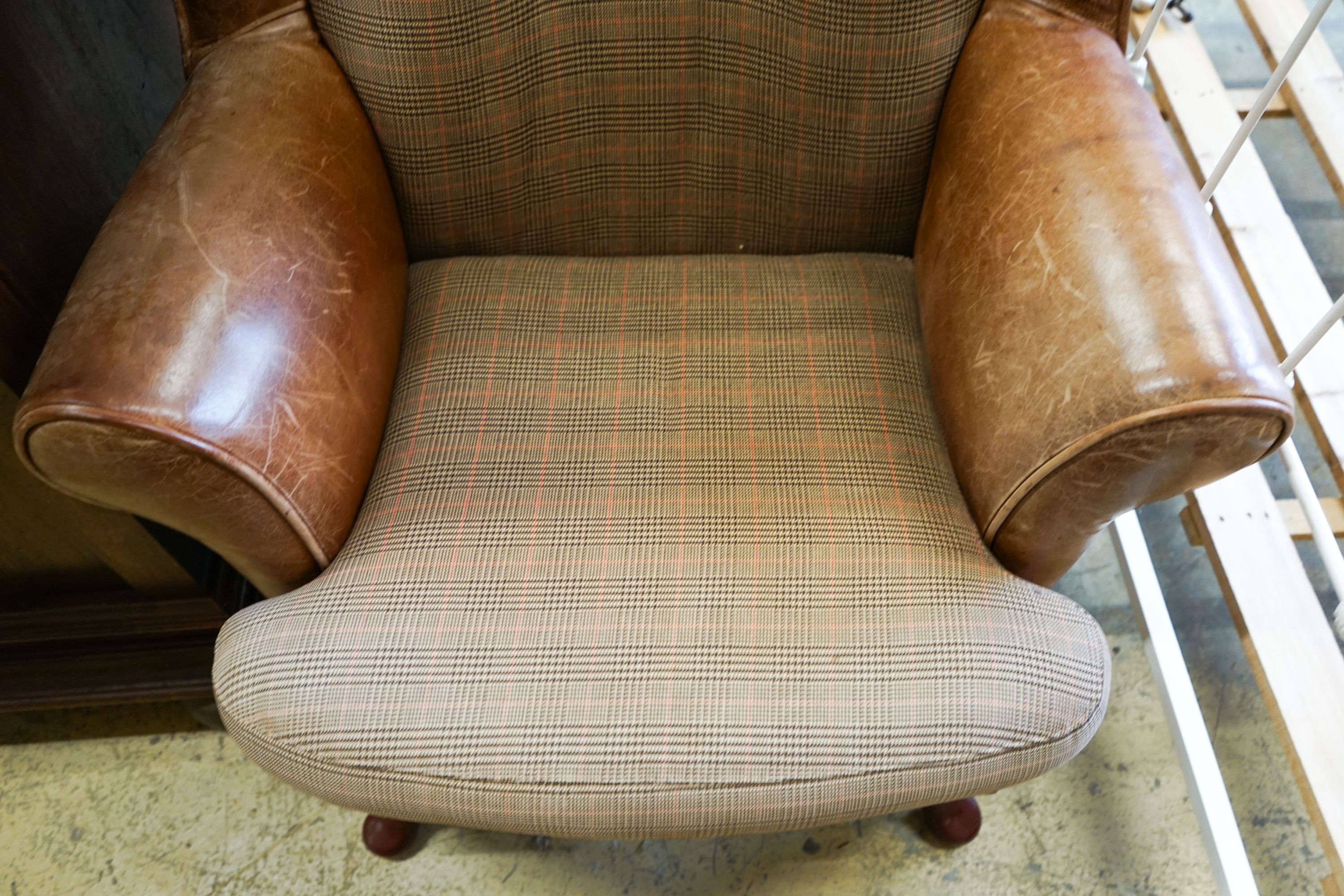 A Victorian style tweed and tan leather wing armchair, width 80cm, depth 84cm, height 98cm